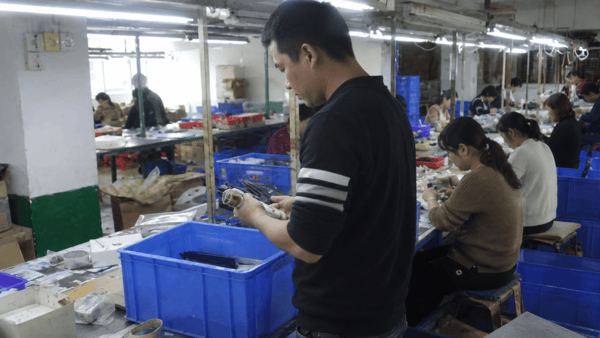 Assembly line workers during a factory verification visit