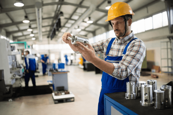 Industrial worker inspecting equipment-related components