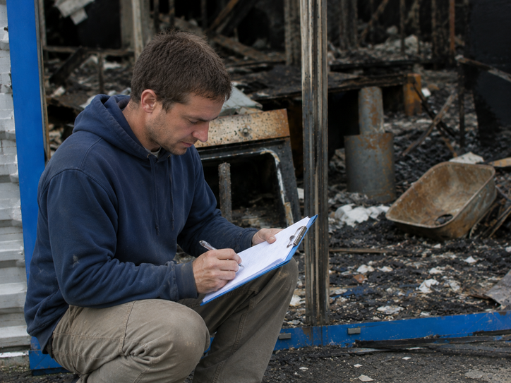Field verifier documenting visible damage